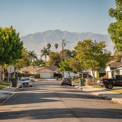 Residential street with the San Gabriel Mountains in the distance in Baldwin Park, California