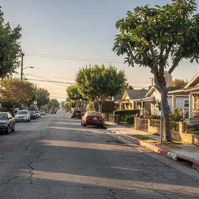 Street of 1920s bungalows with street trees in Florence-Graham, Los Angeles County, California