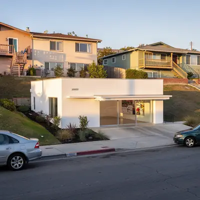 Restored 1936 filling station gallery on a hilly street in Adams Hill, Glendale, California