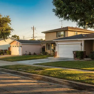 Residential street of homes with lawns and street trees in Lynwood, California