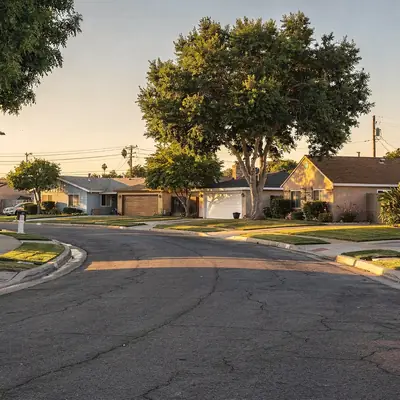 Residential street of ranch homes with lawns in Pico Rivera, California
