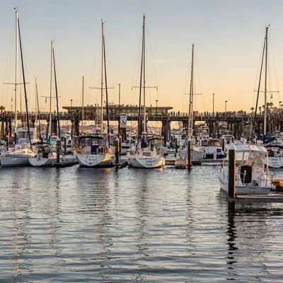 Sailboats in King Harbor marina at golden hour in Redondo Beach, California