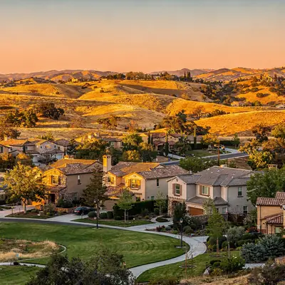 Golden hills above tile-roofed neighborhoods in Valencia, Santa Clarita, California