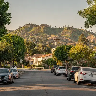 Tree-lined street with the Whittier hills behind in Whittier, California